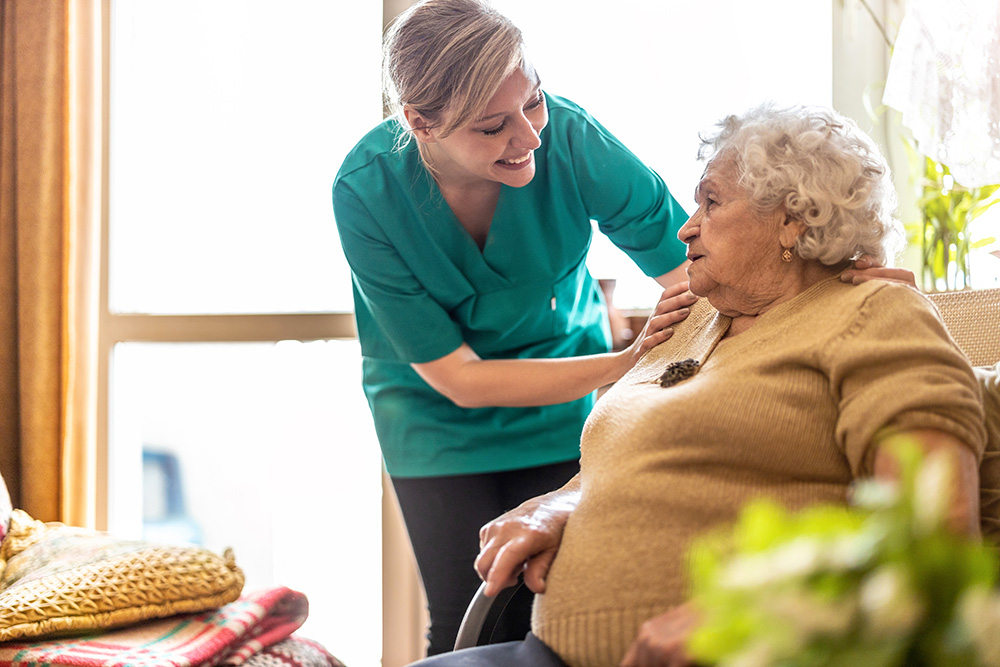 Elderley women being supported in her chair